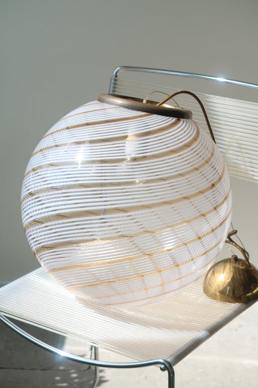 Vintage Murano filigrana loftlampe / pendel i klart glas med gylden og hvid swirl. Giver det fineste mønster på væggen, når solen står på og når den er tændt. Håndlavet i Italien, 1960/70erne, og har messing ophæng. Har i helt original stand. D:40 cm 