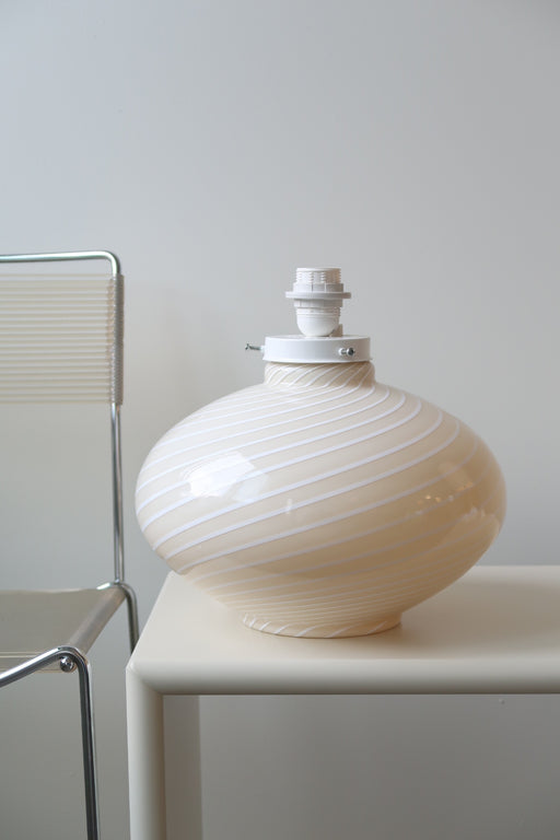 Smuk stor vintage Murano lampefod udført i cream glas med hvid swirl.  Mundblæst i rund form og har dobbelt fatning - dvs. den lyser både i glasbunden og i toppen. Lampen afgiver et meget hyggeligt lys og har en fantastisk swirl. Håndlavet i Italien, 1970erne. murano lamp base swirly round glass