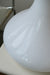 Vintage stor Murano lampefod i hvid glas med hvid swirl. Mundblæst i organisk form og har dobbelt fatning - dvs. den lyser både i glasbunden og i toppen. Lampen afgiver et meget hyggeligt lys og har en fantastisk swirl. Håndlavet i Italien, 1970erne. H:38 cm D:36 